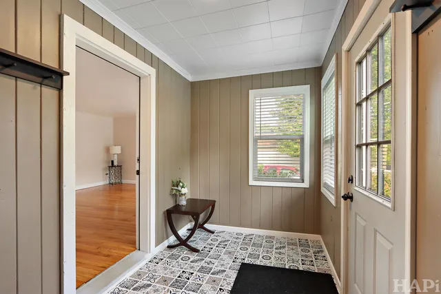 a view of a livingroom with wooden floor and furniture