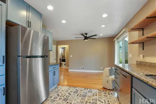 a kitchen with stainless steel appliances granite countertop a refrigerator and a sink