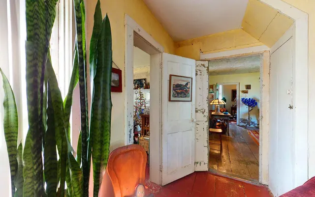 a view of a balcony with red and white door