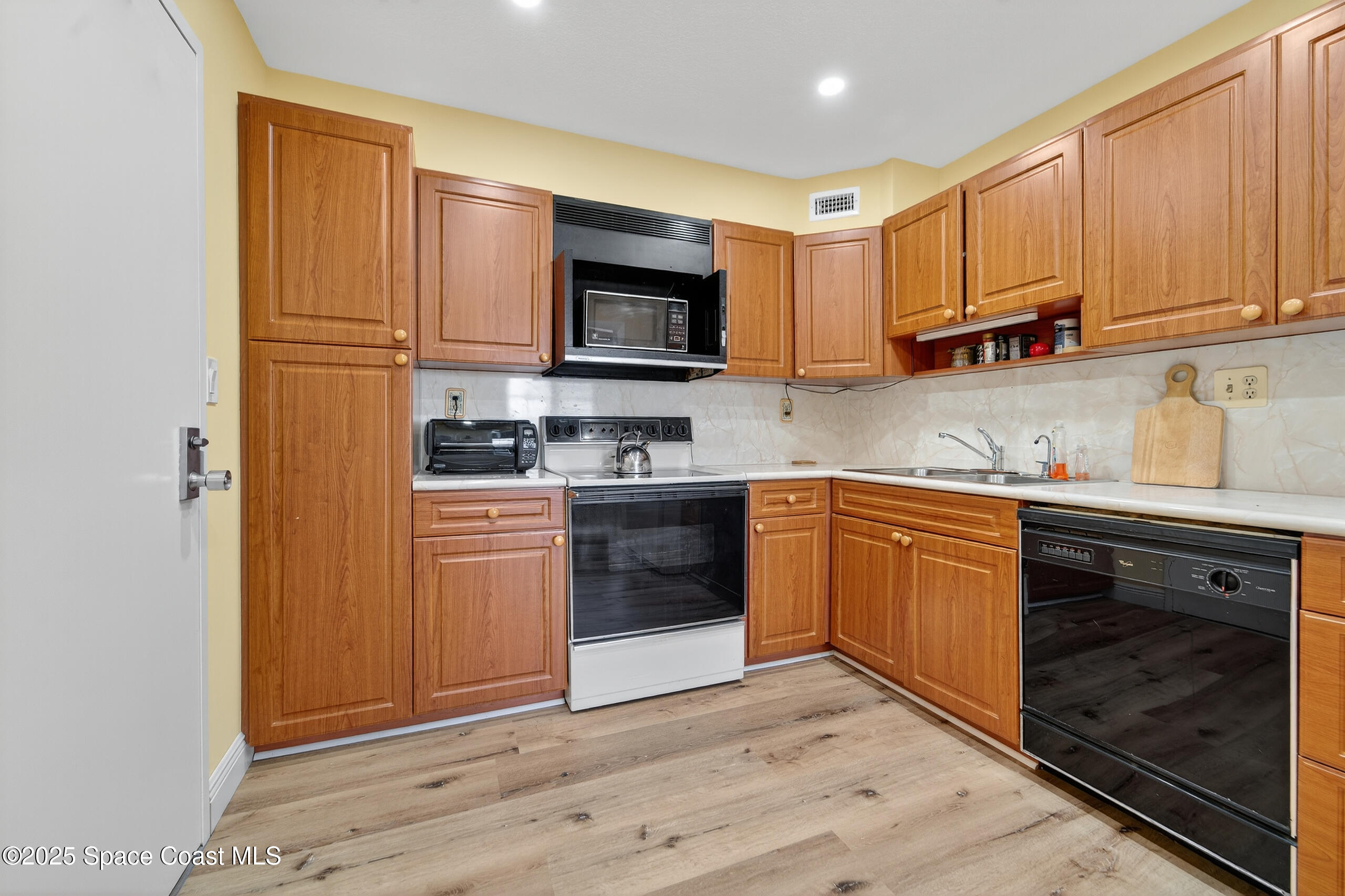 10777 West Sample Road, Unit 1212 Coral Springs, FL 33065 - Photo 13 of 41 a kitchen with stainless steel appliances granite countertop a stove a sink and a refrigerator