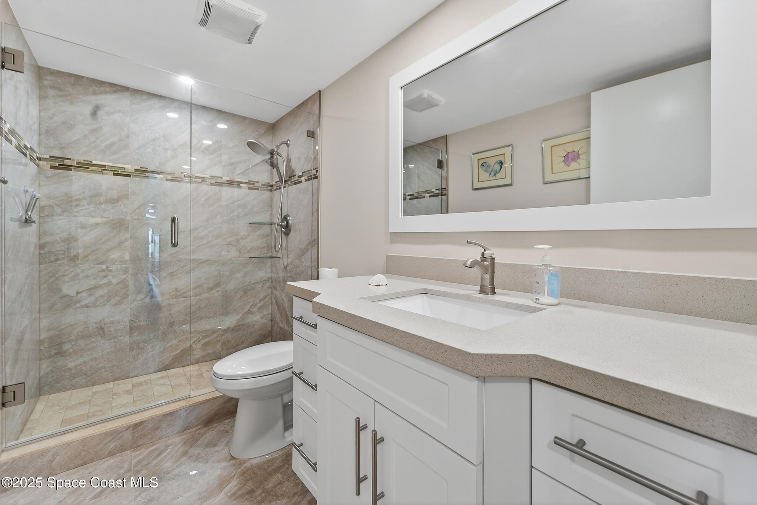 10777 West Sample Road, Unit 1212 Coral Springs, FL 33065 - Photo 20 of 41 a bathroom with a granite countertop sink a toilet and shower