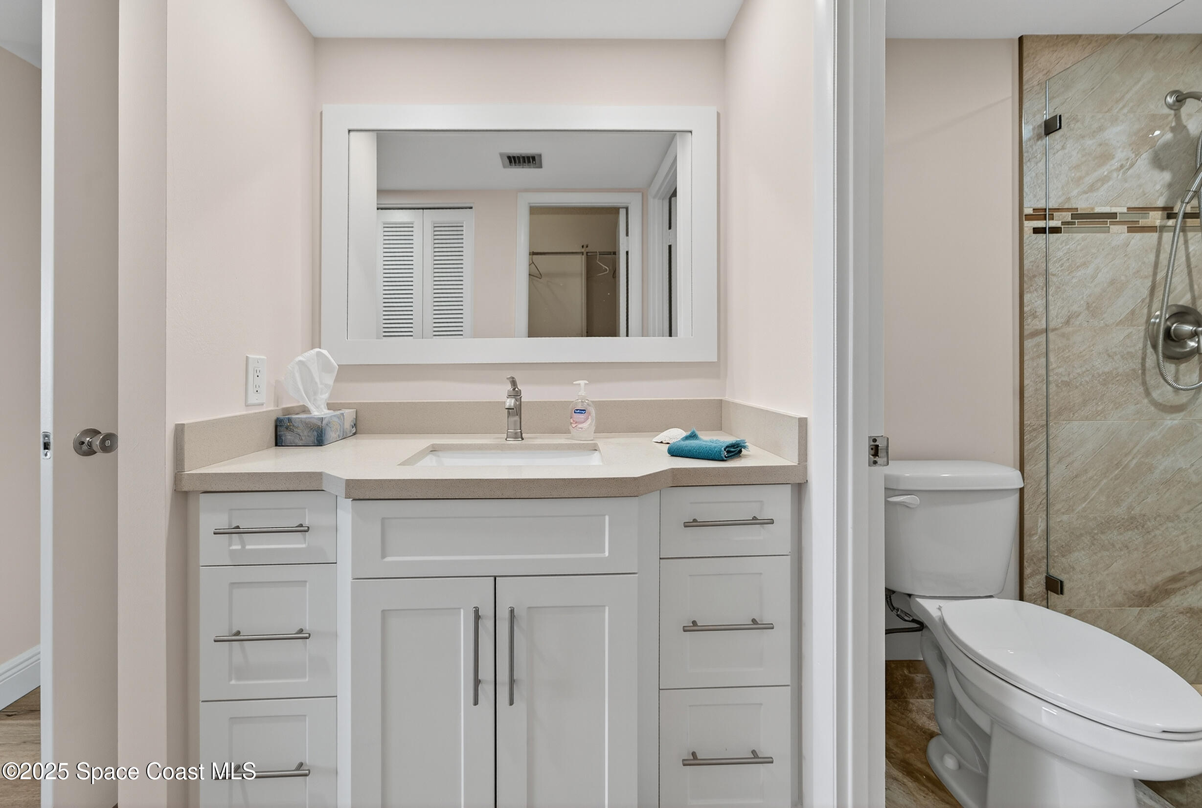 10777 West Sample Road, Unit 1212 Coral Springs, FL 33065 - Photo 24 of 41 a bathroom with a sink a toilet and shower