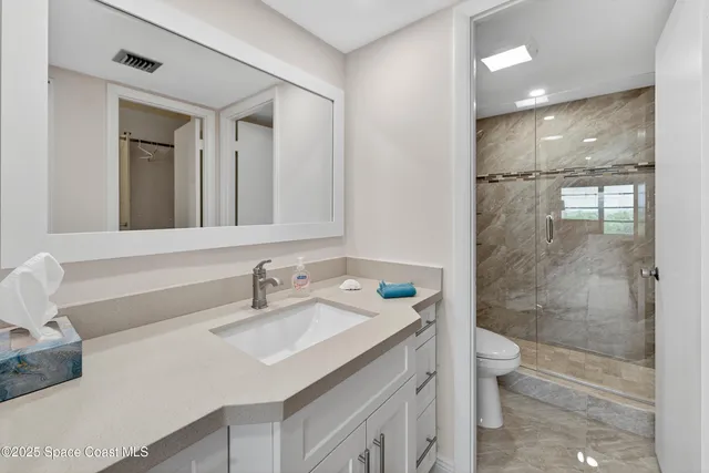 a big room with closet and wooden floor