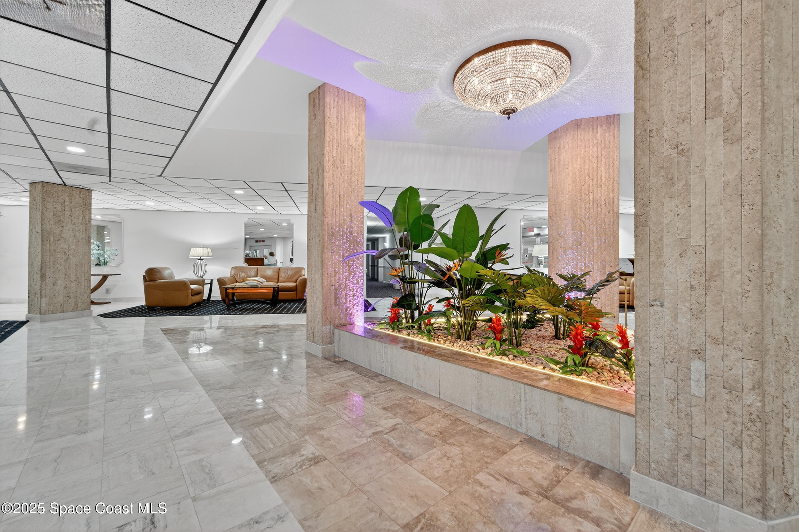 10777 West Sample Road, Unit 1212 Coral Springs, FL 33065 - Photo 29 of 41 a view of living room filled with furniture and a chandelier