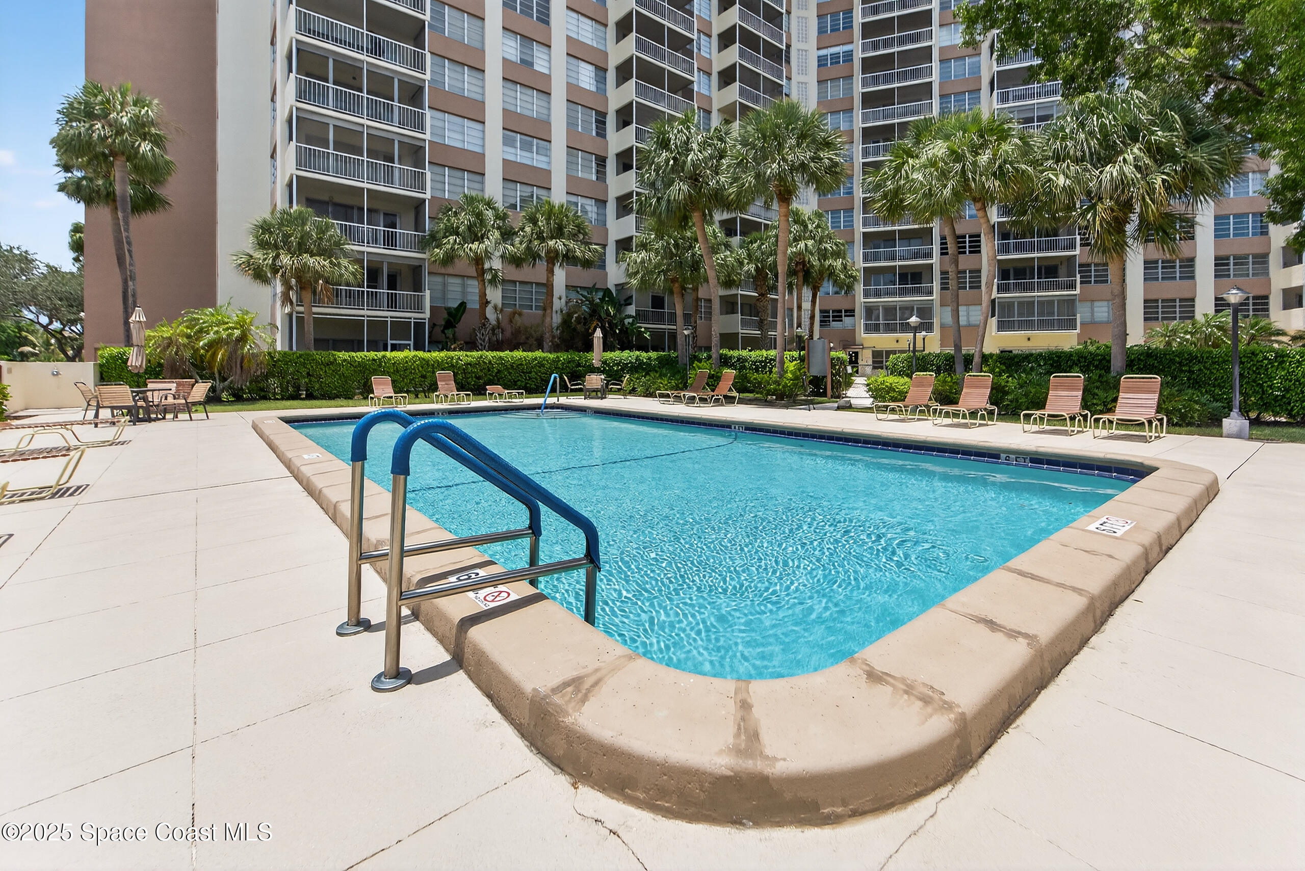 10777 West Sample Road, Unit 1212 Coral Springs, FL 33065 - Photo 32 of 41 a view of a swimming pool with a patio