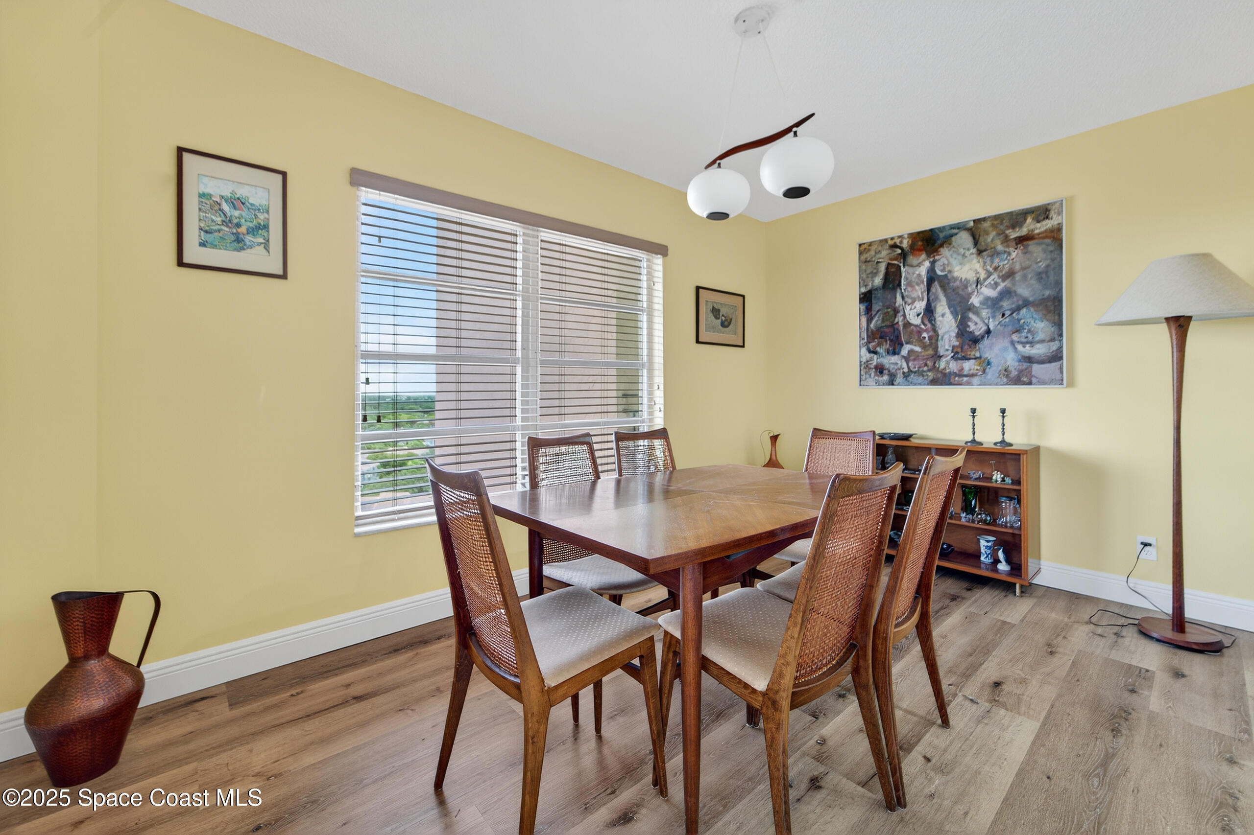10777 West Sample Road, Unit 1212 Coral Springs, FL 33065 - Photo 10 of 41 a view of a dining room with furniture and wooden floor