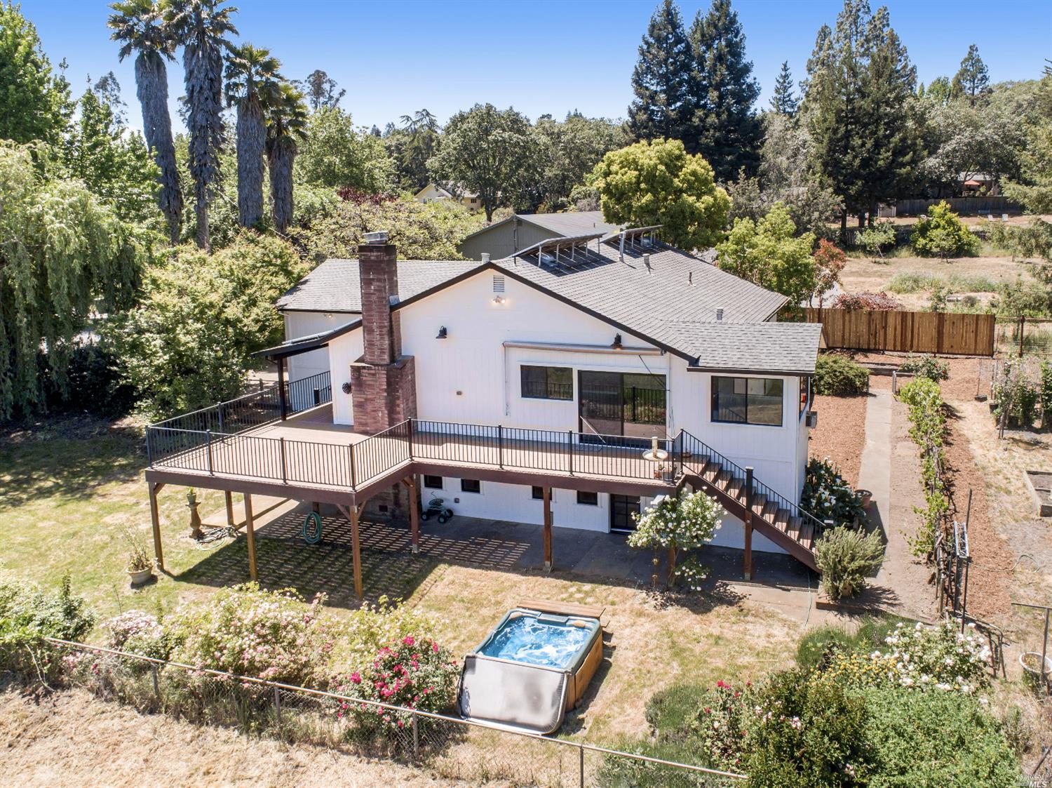 a aerial view of a house with swimming pool and sitting area
