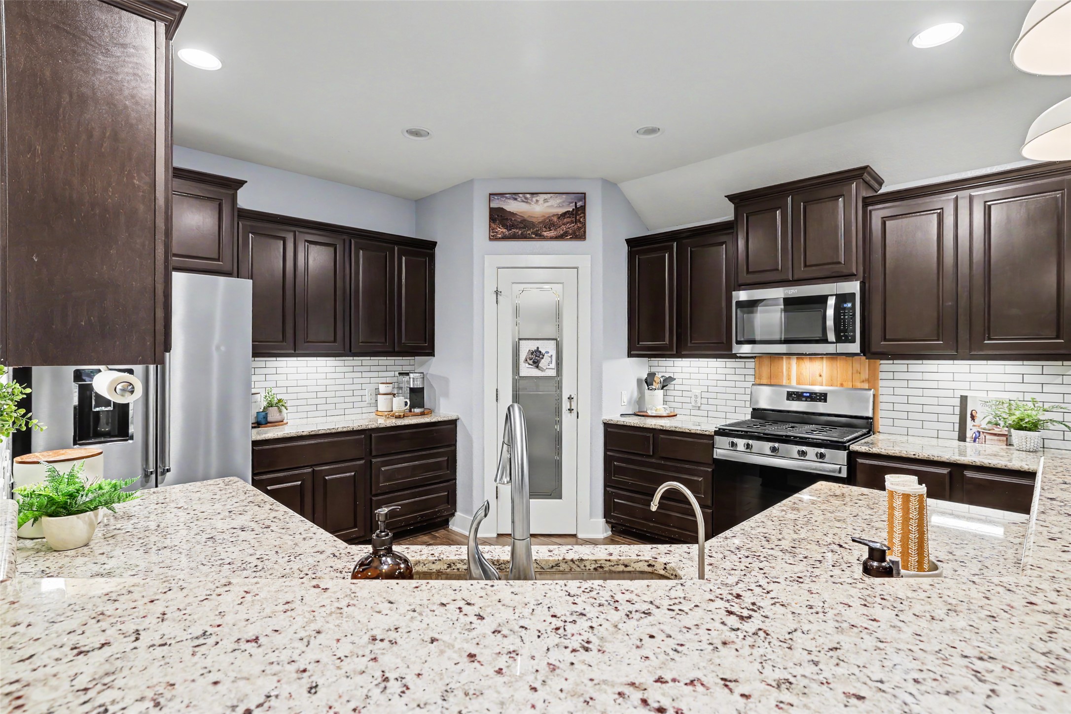 117 Rock Dock Road Georgetown, TX 78633 - Photo 13 of 38 a kitchen with stainless steel appliances kitchen island granite countertop a refrigerator stove and sink