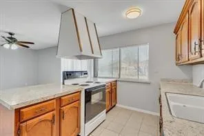 a kitchen with stainless steel appliances granite countertop a sink a stove and a refrigerator