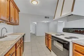 a kitchen with stainless steel appliances granite countertop a sink and a stove