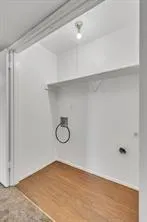 a view of a room with wooden floor and white walls