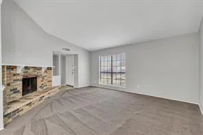 a view of an empty room with a fireplace