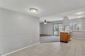 an empty room with windows and cabinet