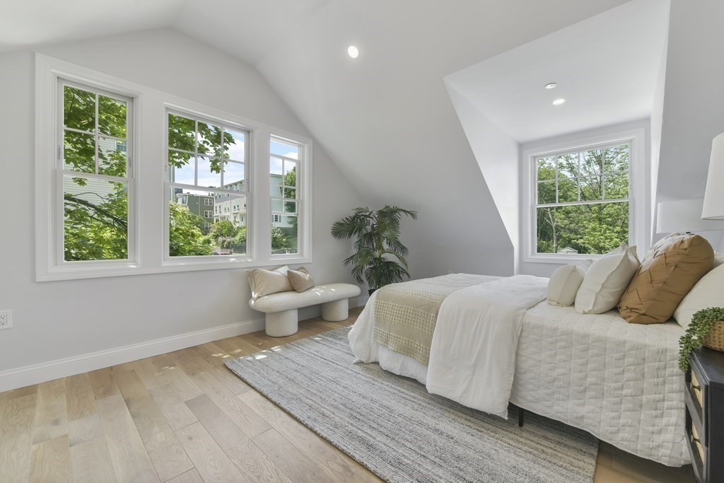 137 Falcon Street, Unit 4 Boston, MA 02128 - Photo 11 of 22 a bedroom with a large bed and a potted plant