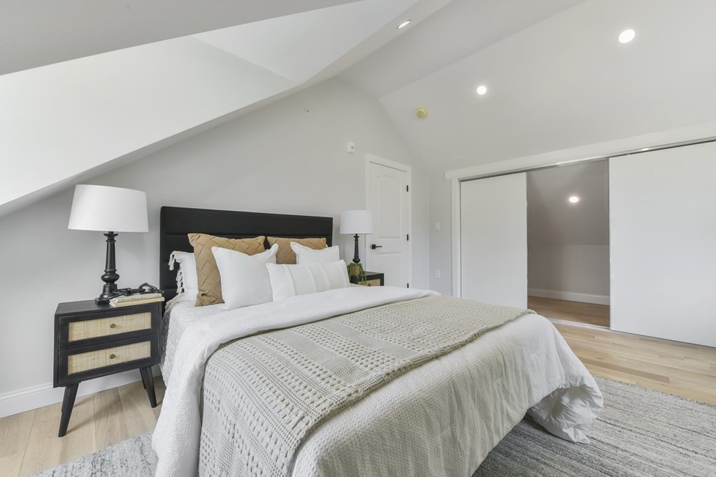 137 Falcon Street, Unit 4 Boston, MA 02128 - Photo 13 of 22 a bedroom with a bed and a lamp