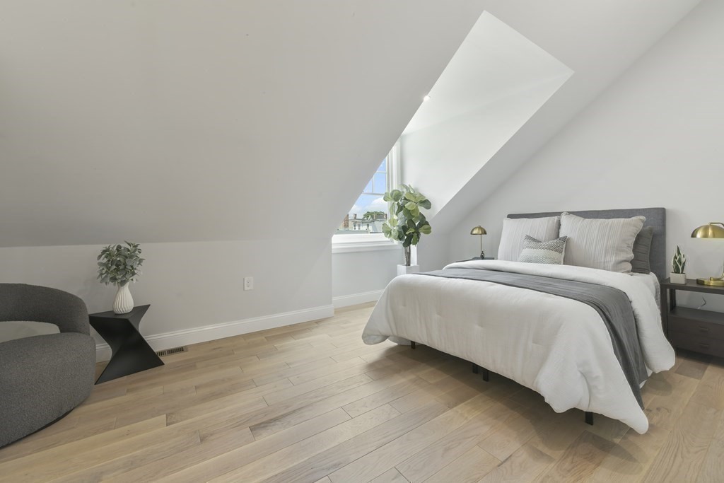 137 Falcon Street, Unit 4 Boston, MA 02128 - Photo 14 of 22 a bedroom with a bed and a potted plant