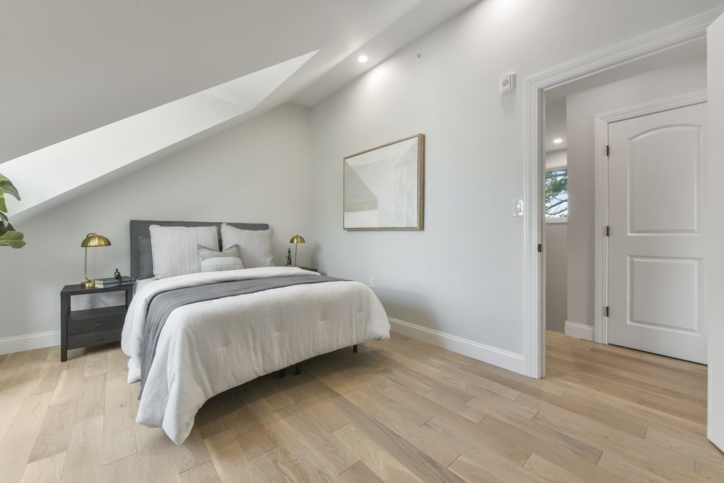 137 Falcon Street, Unit 4 Boston, MA 02128 - Photo 15 of 22 a bedroom with a bed and wooden floor
