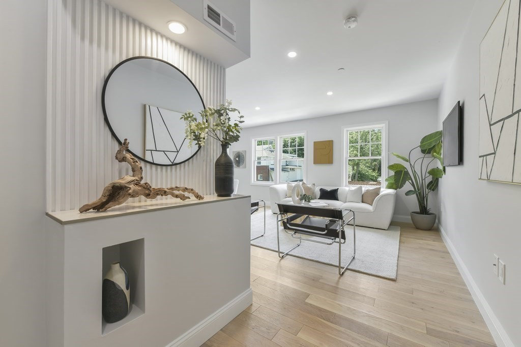 137 Falcon Street, Unit 4 Boston, MA 02128 - Photo 10 of 22 a living room with furniture a fireplace and a potted plant