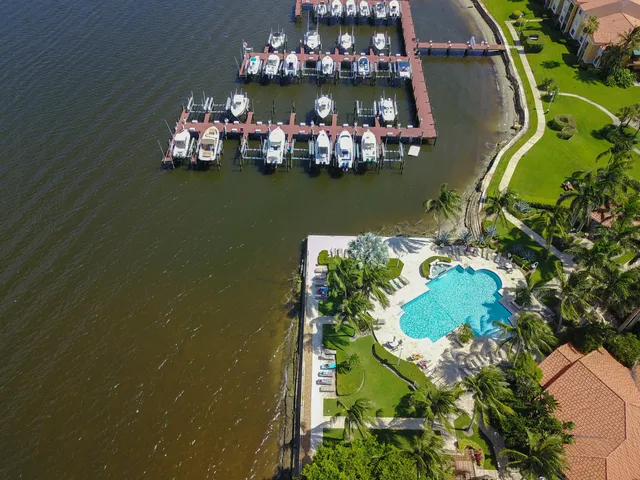 an aerial view of a house with a yard and lake view
