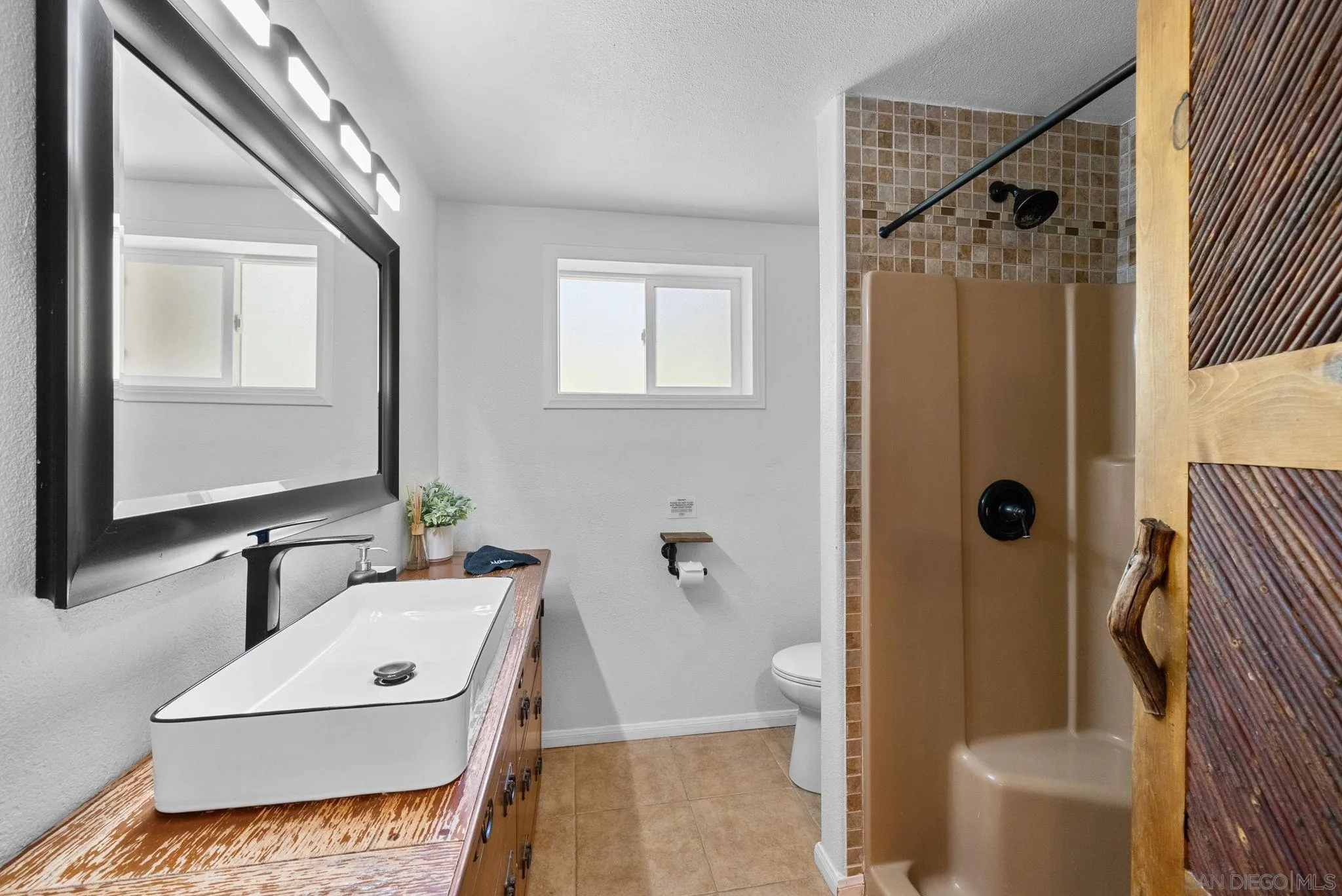 15914 Sequan Truck Trail Alpine, CA 91901 - Photo 18 of 69 a bathroom with a sink a toilet a mirror and shower