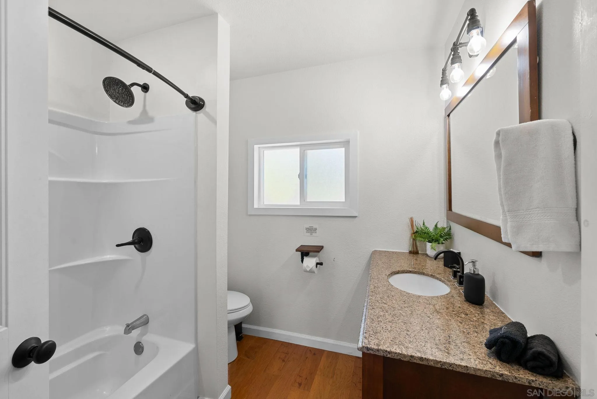 15914 Sequan Truck Trail Alpine, CA 91901 - Photo 25 of 69 a bathroom with a granite countertop sink a mirror and shower