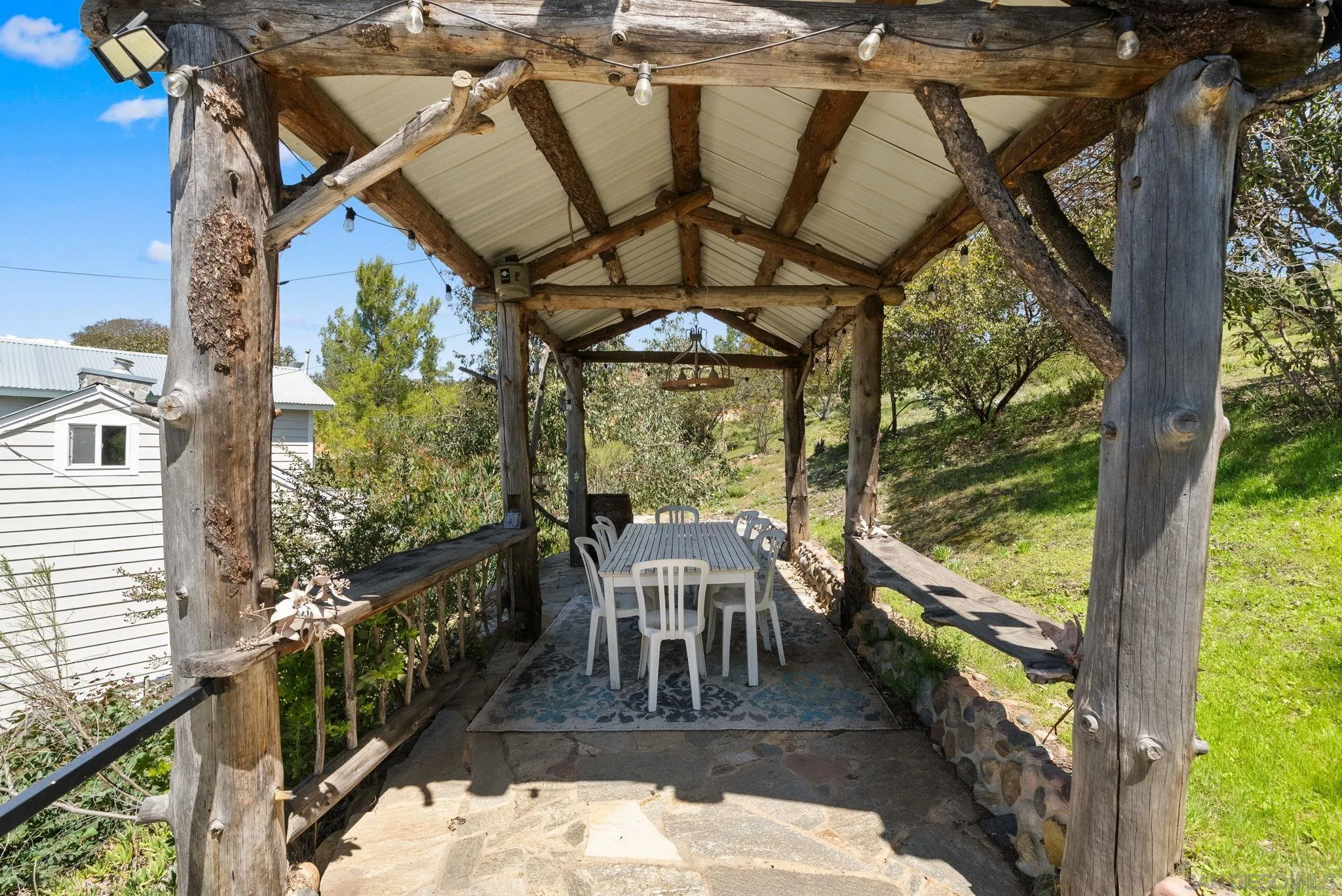 15914 Sequan Truck Trail Alpine, CA 91901 - Photo 42 of 69 a view of a patio with a table chairs and a backyard