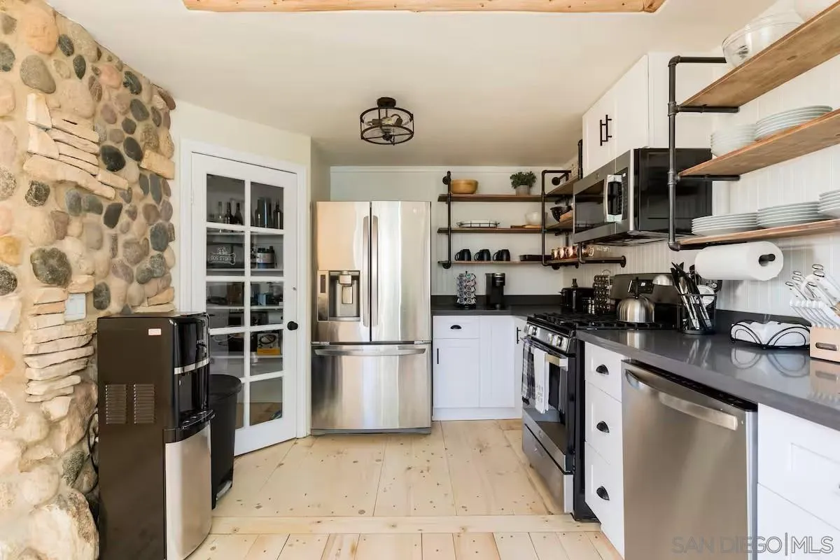 15914 Sequan Truck Trail Alpine, CA 91901 - Photo 9 of 69 a kitchen with stainless steel appliances granite countertop a refrigerator and a stove