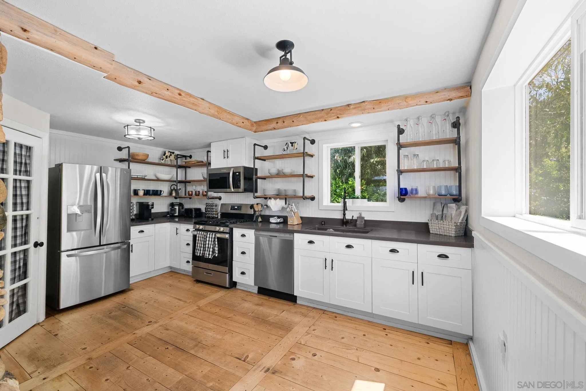 15914 Sequan Truck Trail Alpine, CA 91901 - Photo 10 of 69 a kitchen with granite countertop a refrigerator and white cabinets