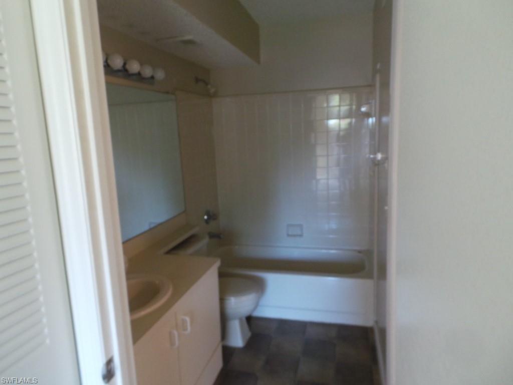 13521 Eagle Ridge Drive, Unit 128 Fort Myers, FL 33912 - Photo 14 of 14 a bathroom with a tub and sink