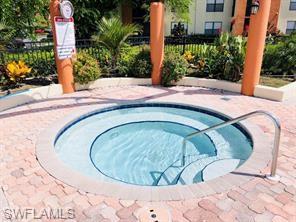 13521 Eagle Ridge Drive, Unit 128 Fort Myers, FL 33912 - Photo 7 of 14 a swimming pool with trees in the background