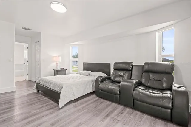 a bedroom with a bed and a couch