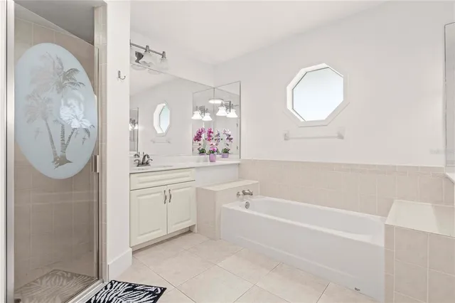 a bathroom with a tub sink and mirror