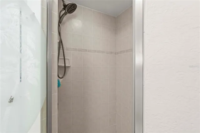 a bathroom with a glass shower door