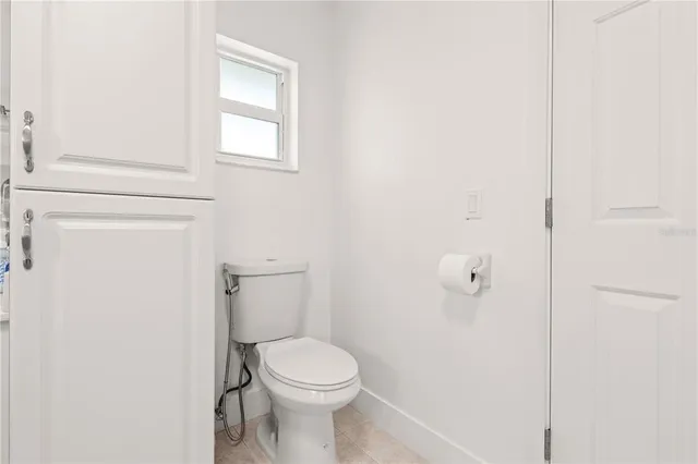 a white toilet sitting next to a bathroom sink