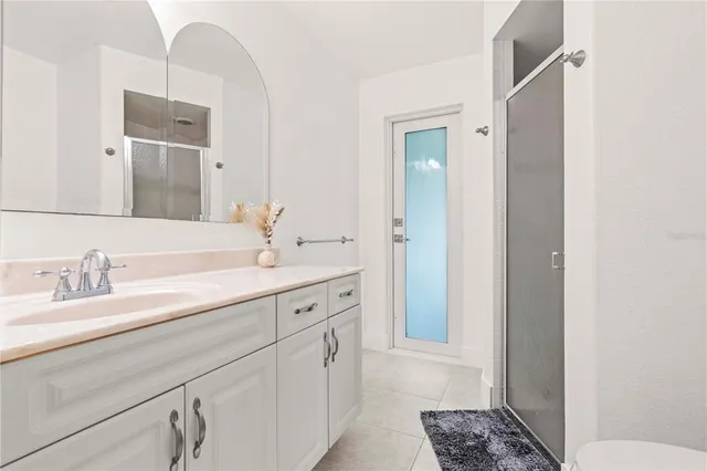 a spacious bathroom with a double vanity sink and mirror
