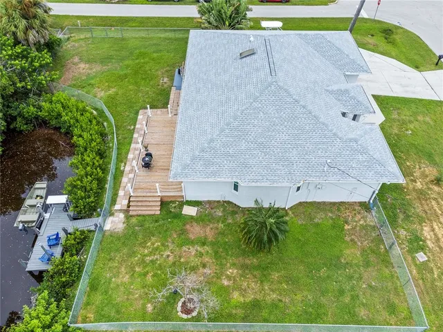 an aerial view of a house with garden space and street view