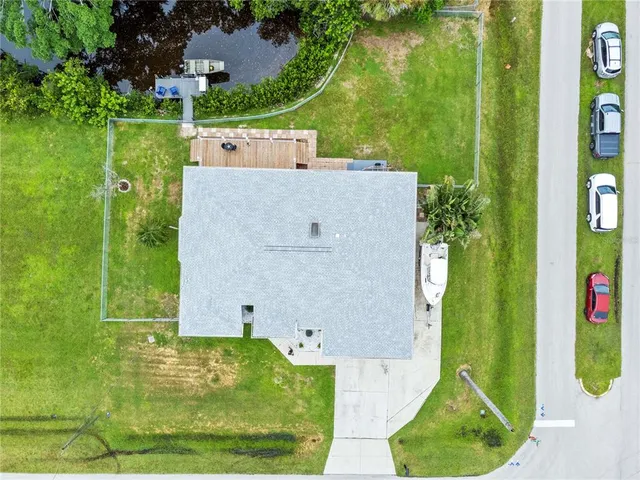 an aerial view of a house with a garden and swimming pool