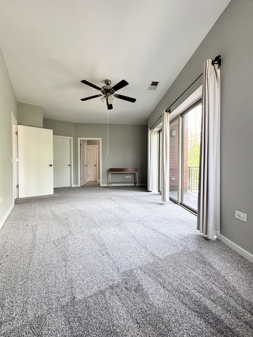 1075 West Roosevelt Road, Unit 305 Chicago, IL 60608 - Photo 20 of 23 a view of a livingroom with a ceiling fan and window