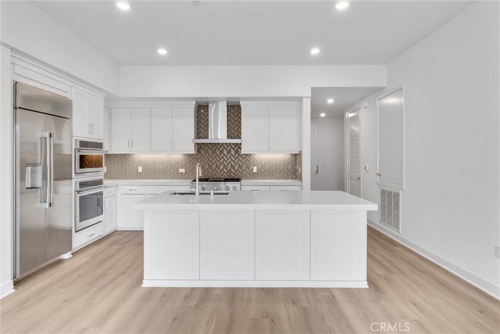 4302 Rivington Irvine, CA 92612 - Photo 15 of 63 a living room with stainless steel appliances furniture a refrigerator and wooden floor