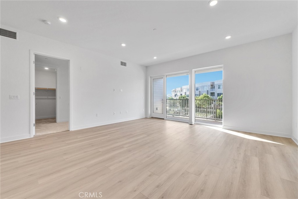 4302 Rivington Irvine, CA 92612 - Photo 19 of 63 a view of an empty room with wooden floor and a window