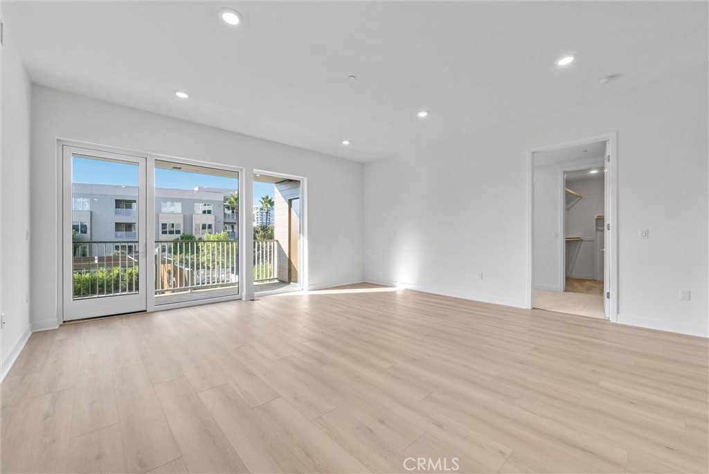 4302 Rivington Irvine, CA 92612 - Photo 21 of 63 a view of an empty room with wooden floor and a sliding door