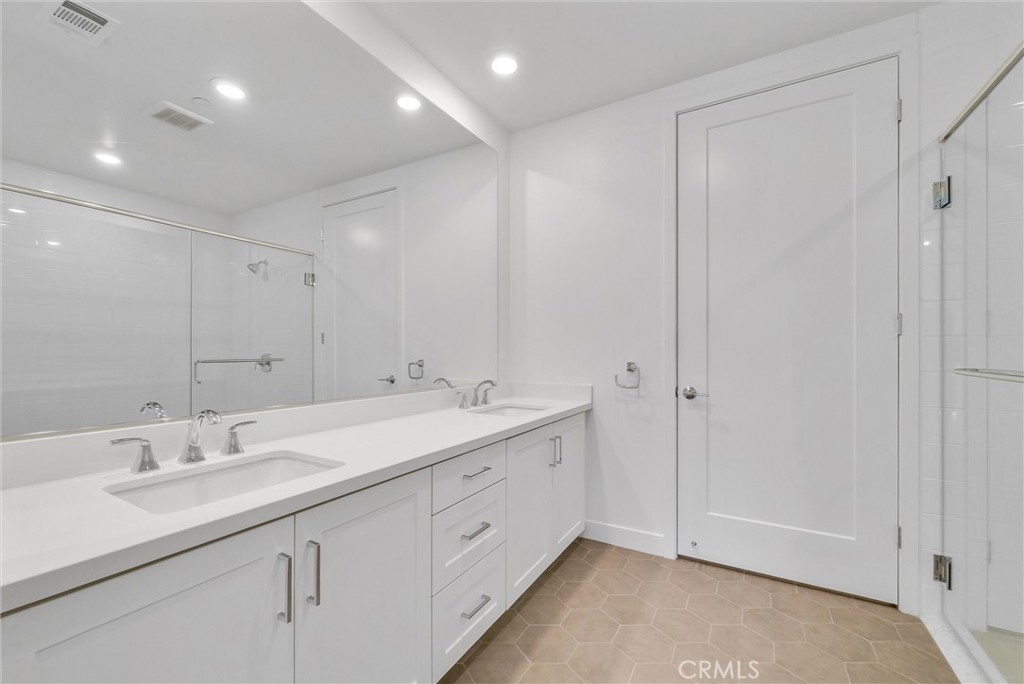 4302 Rivington Irvine, CA 92612 - Photo 28 of 63 a bathroom with a double vanity sink and a mirror