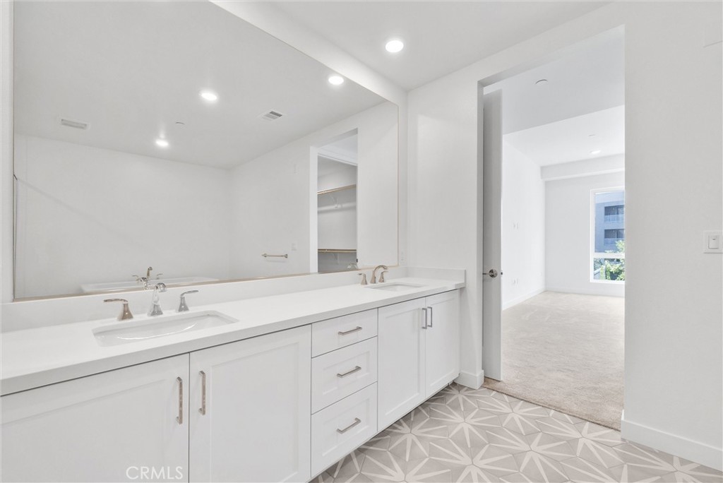 4302 Rivington Irvine, CA 92612 - Photo 36 of 63 a spacious bathroom with a double vanity sink and a mirror
