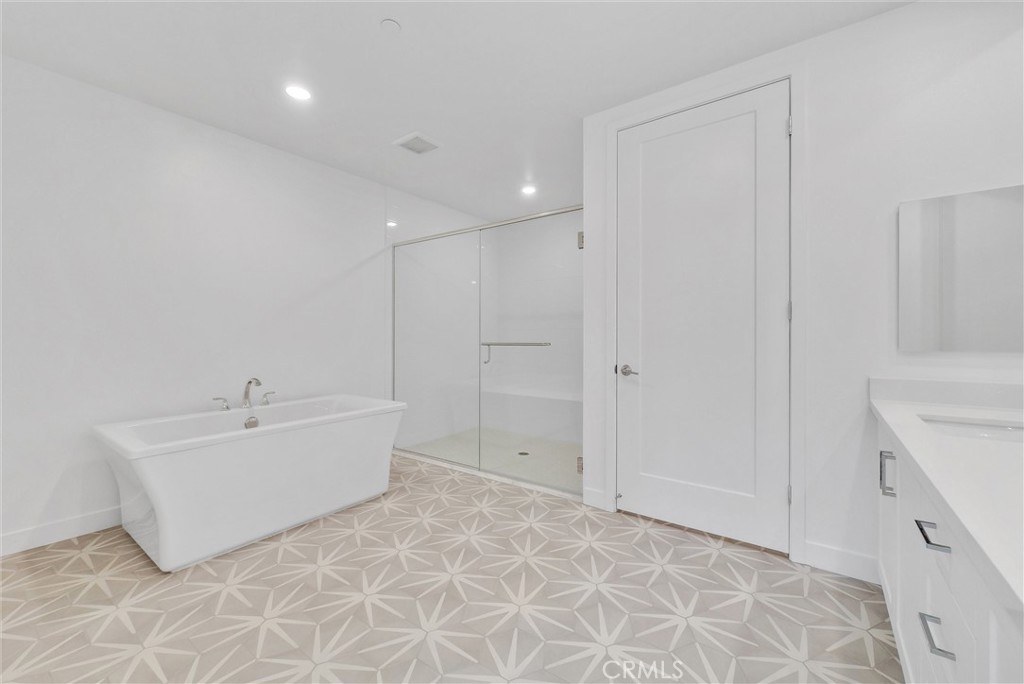 4302 Rivington Irvine, CA 92612 - Photo 37 of 63 a bathroom with a bathtub sink and mirror