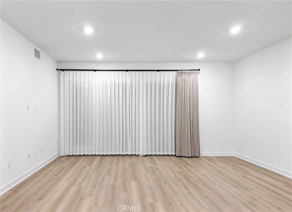4302 Rivington Irvine, CA 92612 - Photo 63 of 63 an empty room with wooden floor and windows