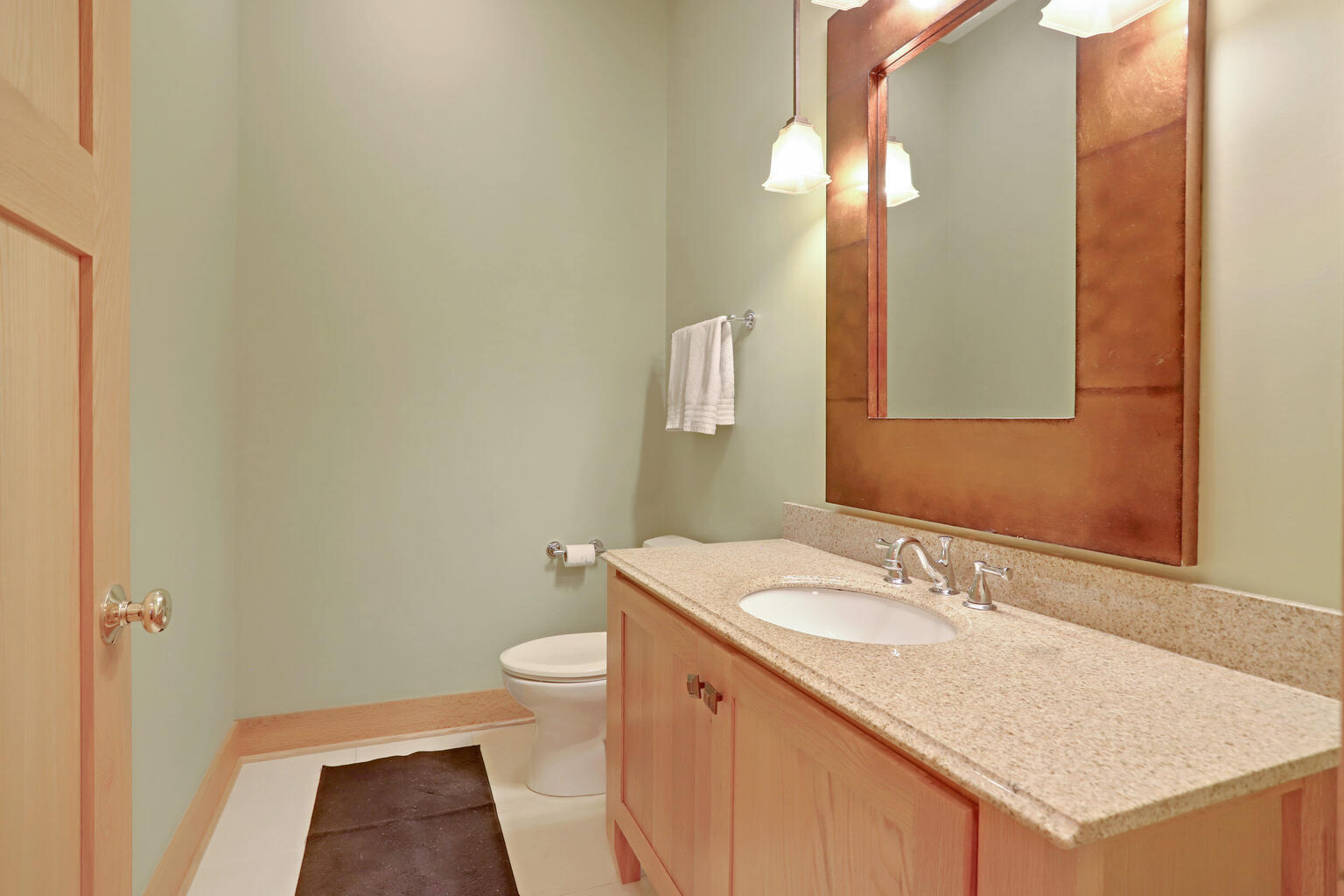 1011 West Charles Street Champaign, IL 61821 - Photo 19 of 51 a bathroom with a granite countertop sink toilet and a mirror