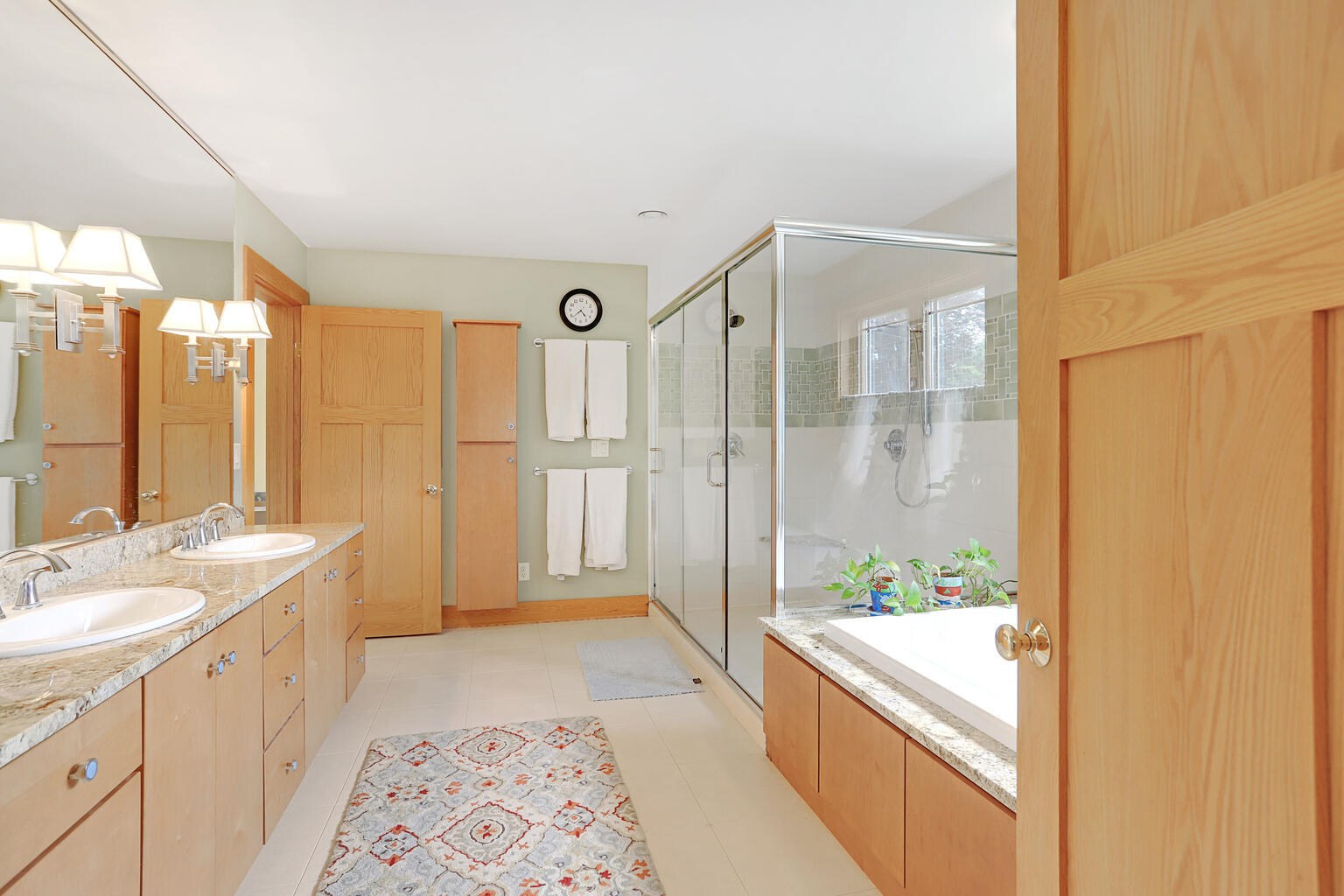 1011 West Charles Street Champaign, IL 61821 - Photo 22 of 51 a spacious bathroom with a double vanity sink and a bathtub