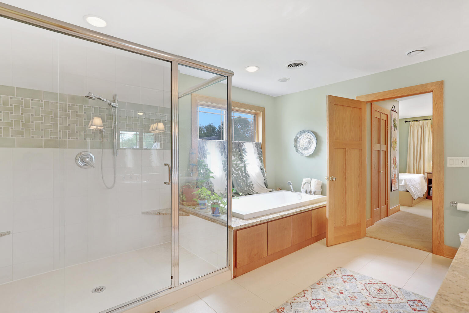 1011 West Charles Street Champaign, IL 61821 - Photo 23 of 51 a bathroom with a double vanity sink toilet and shower