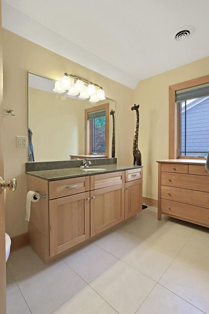 1011 West Charles Street Champaign, IL 61821 - Photo 32 of 51 a spacious bathroom with a granite countertop sink mirror and a bathtub