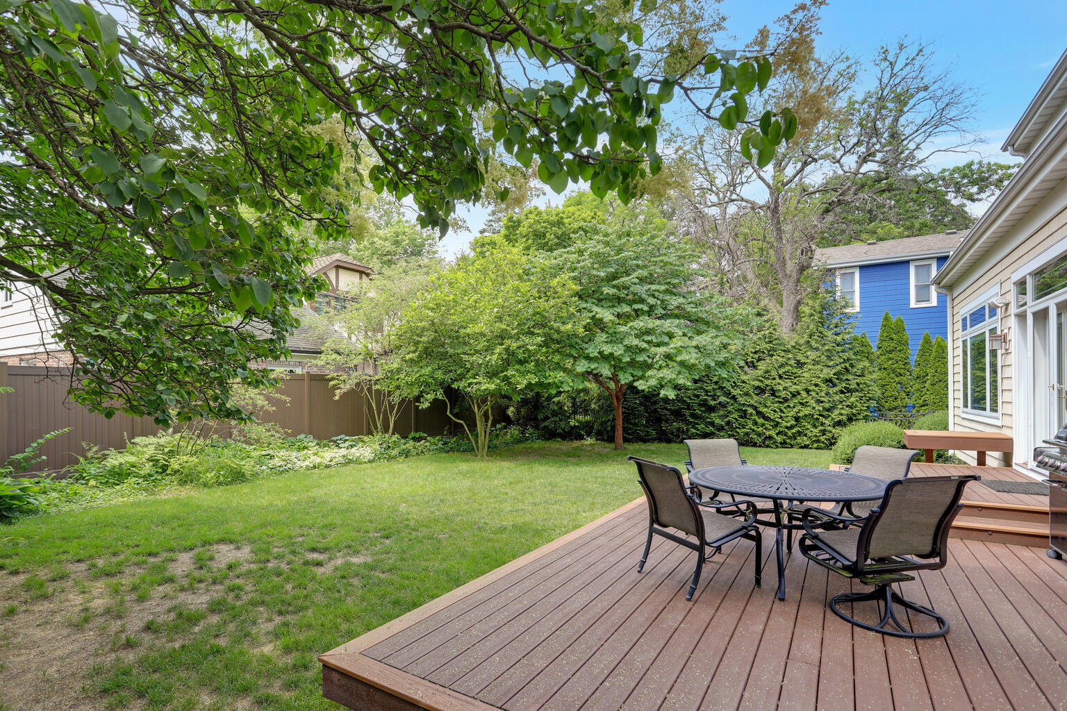 1011 West Charles Street Champaign, IL 61821 - Photo 47 of 51 a view of a backyard with table and chairs potted plants and large tree